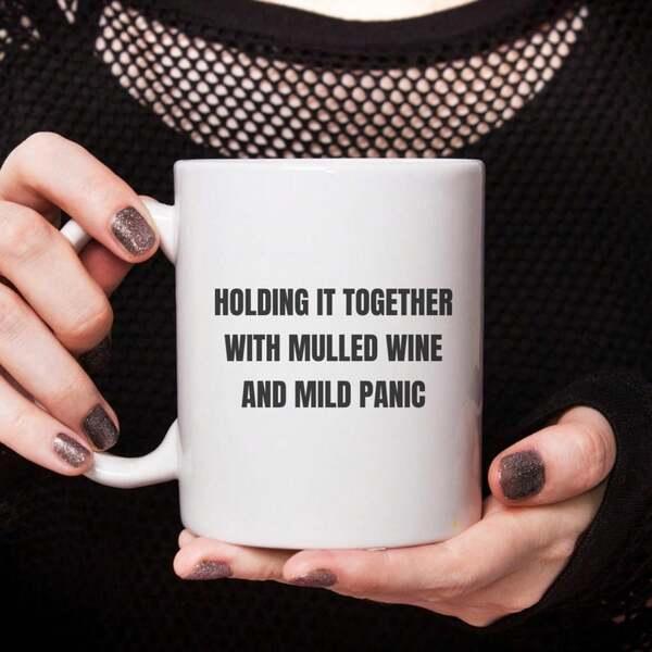 Tailorly White Ceramic 11 oz Mug - Holding It Together With Mulled Wine And Mild Panic Minimalist White Ceramic Vessel Held By Hands Against Dark Background Mug