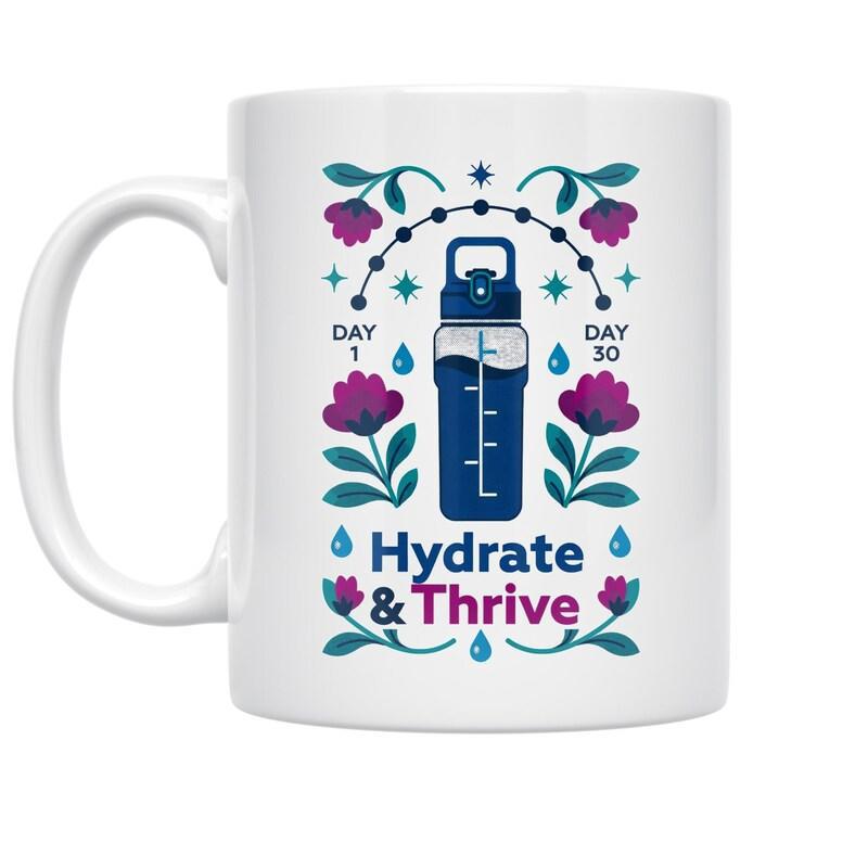 Tailorly White Ceramic 11 oz Mug - Hydrate Thrive Vibrant Flowers And Water Droplets Surrounding A Modern Reusable Bottle