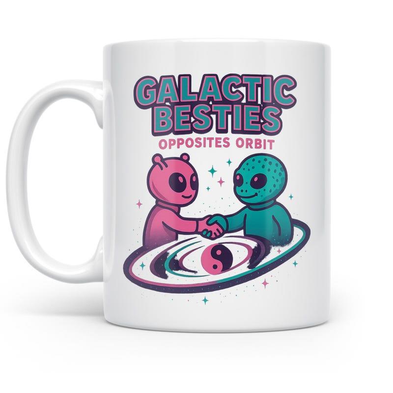 Tailorly White Ceramic 11 oz Mug - Galactic Besties Opposites Orbit Two Friendly Cartoon Creatures Shaking Hands Over A Swirling Galaxy Alien