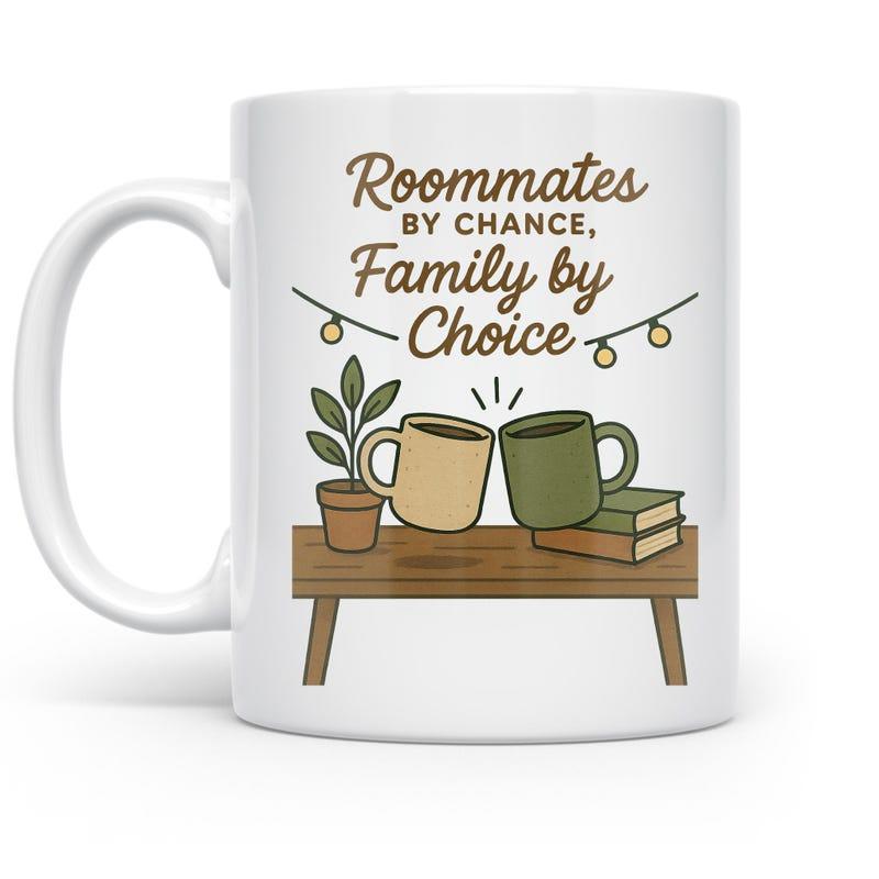 Tailorly White Ceramic 11 oz Mug - Roommates By Chance Family By Choice Two Mugs Clinking On A Wooden Table Near Potted Plant And Books Mug
