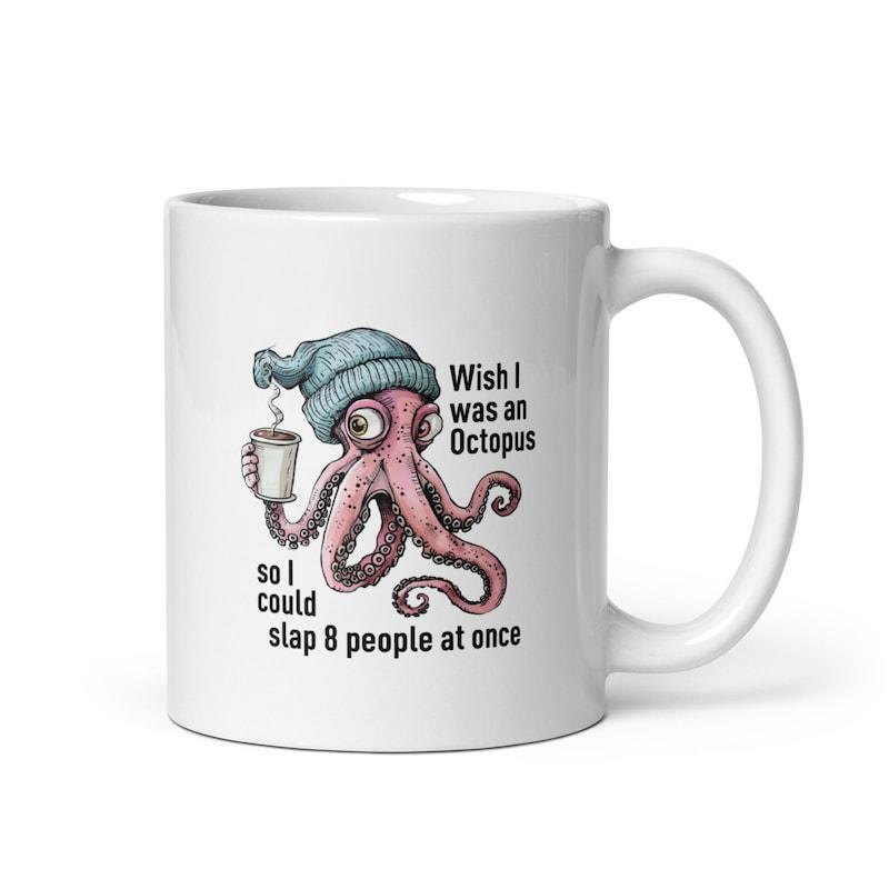 Tailorly White Ceramic 11 oz Mug - Wish I Was An Octopus So I Could Slap 8 People At Once Whimsical Pink Sea Creature Wearing Blue Beanie Holding Coffee Octopus