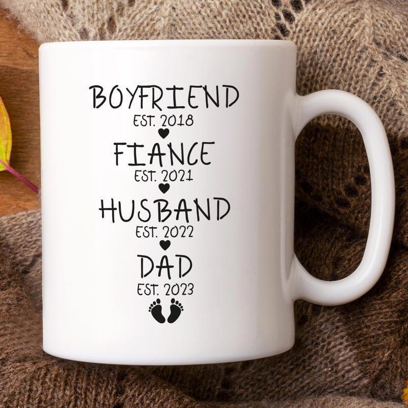 Tailorly White Ceramic 11 oz Mug - Boyfriend Fiance Husband Dad Est 2018 2021 2022 2023 Vertical Milestone Layout Decorated With Small Hearts And Cute Footprints