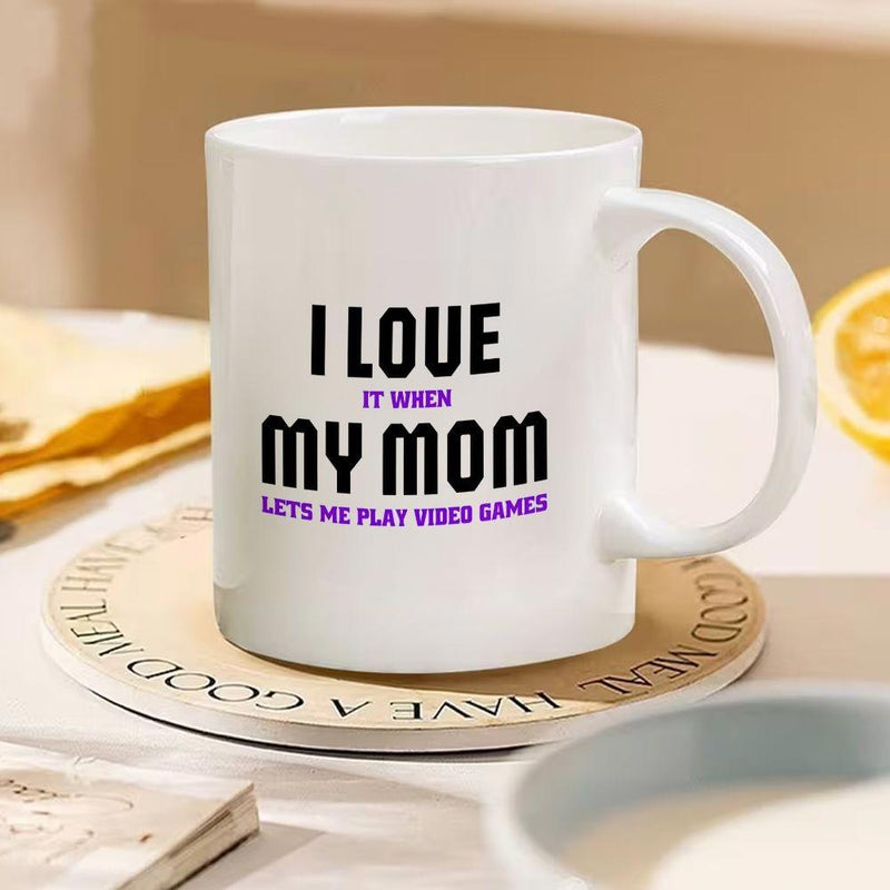 Tailorly White Ceramic 11 oz Mug - I Love It When My Mom Lets Me Play Video Games Minimalist White Ceramic With Bold Black And Purple Typography Lettering Mug