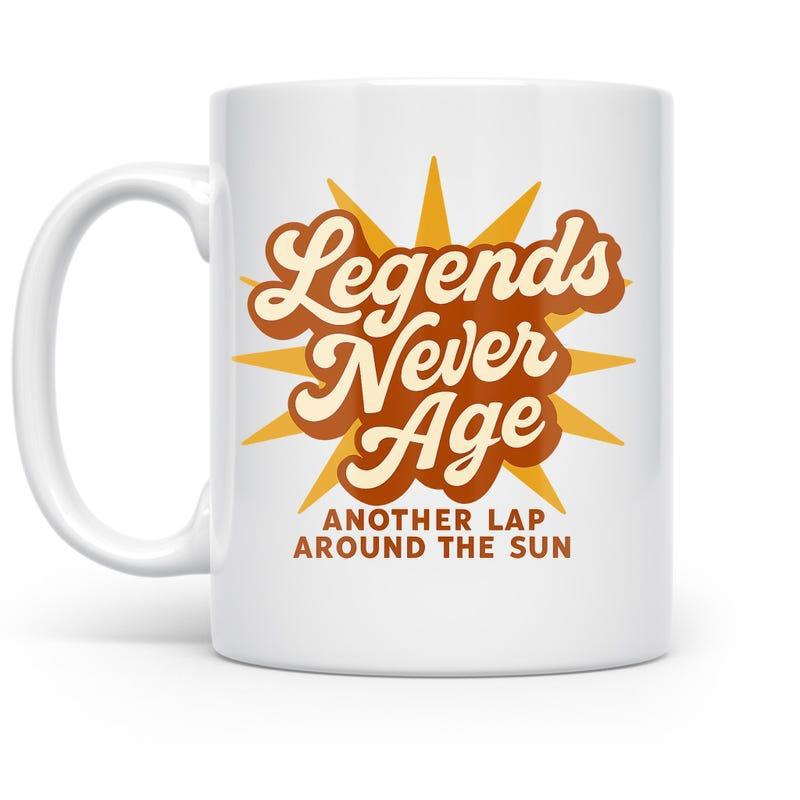 Tailorly White Ceramic 11 oz Mug - Legends Never Age Another Lap Around The Sun Retro Style Radiating Sunburst With Vibrant Yellow Rays And Classic Typography