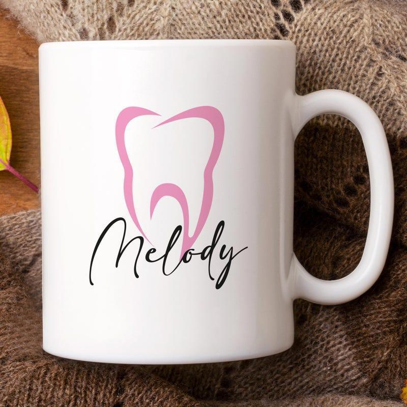 Tailorly White Ceramic 11 oz Mug - Melody Stylized Pink Molar Outline Floating On A Polished White Ceramic Tooth