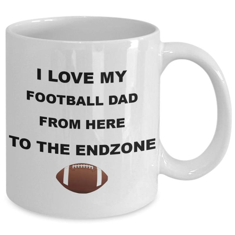 Tailorly White Ceramic 11 oz Mug - I Love My Football Dad From Here To The Endzone Classic Brown American Football With White Stripes Centered Below The Slogan