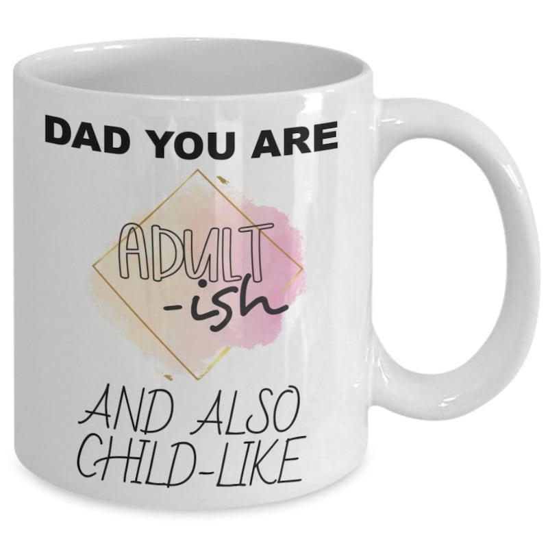 Tailorly White Ceramic 11 oz Mug - Dad You Are Adult Ish And Also Child Like Geometric Diamond Frame With Soft Pink Watercolor Splash Behind Artistic Text Mug