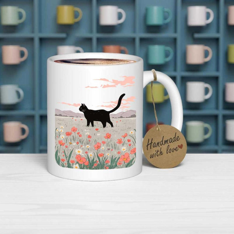 Tailorly White Ceramic 11 oz Mug - Walking Through A Colorful Blooming Wildflower Field Under Soft Clouds Cat