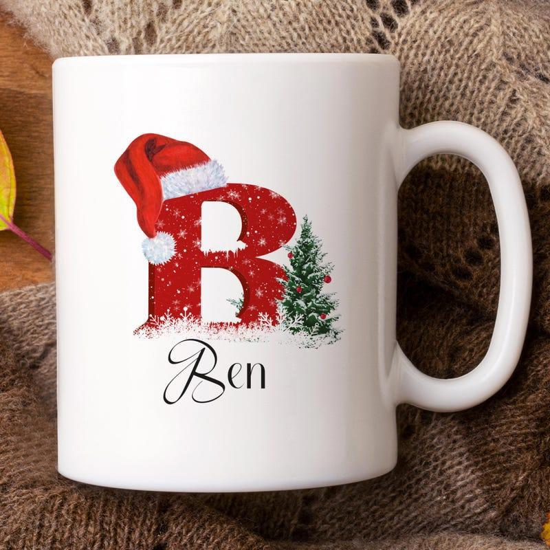 Tailorly White Ceramic 11 oz Mug - Ben Festive Red Patterned Letter Wearing Santa Hat Beside Decorated Pine Christmas Tree Letter