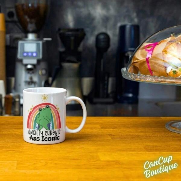 Tailorly White Ceramic 11 oz Mug - Anxiety Chronic Ass Iconic Colorful Rainbow Arching Above An Anxious Grumpy Little Green Frog
