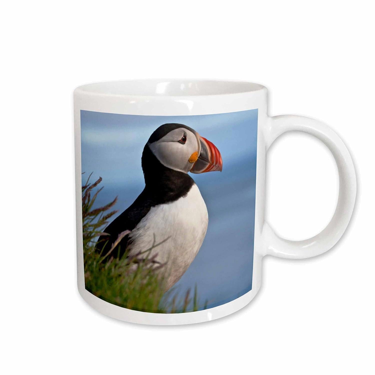 Tailorly White Ceramic 11 oz Mug - Majestic Atlantic Puffin Perched Amidst Green Grass Against Serene Blue Ocean Backdrop Puffin