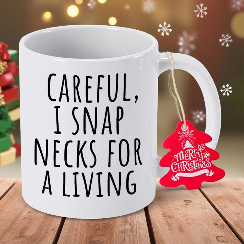 Tailorly White Ceramic 11 oz Mug - Careful I Snap Necks For A Living Minimalist Clean White Ceramic Vessel Resting Upon Textured Brown Wooden Planks Mug