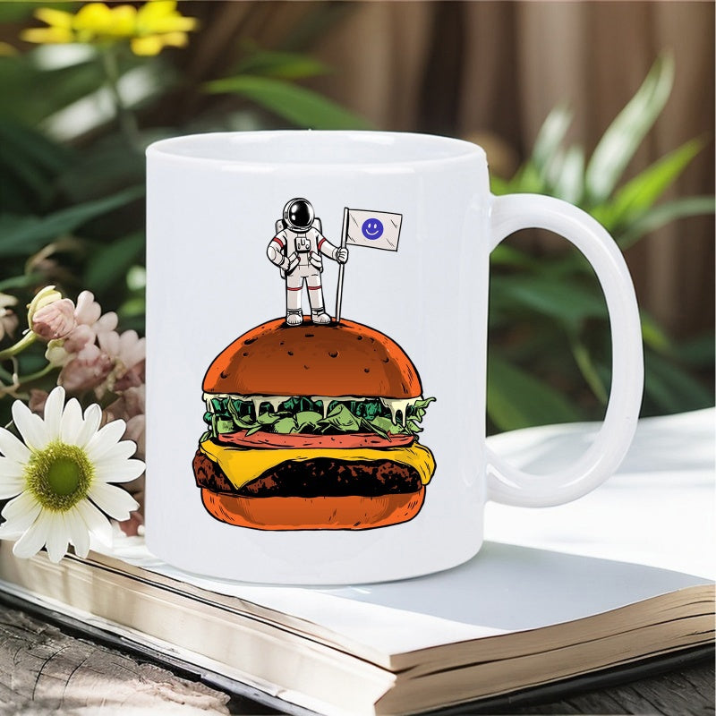Tailorly White Ceramic 11 oz Mug - Whimsical Space Explorer Holding A Flag On Top Of A Giant Delicious Burger