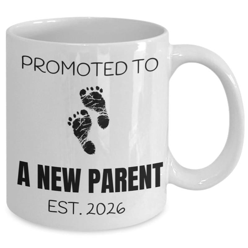 Tailorly White Ceramic 11 oz Mug - Promoted To A New Parent Est 2026 Tiny Black Baby Footprints Stamped On Clean