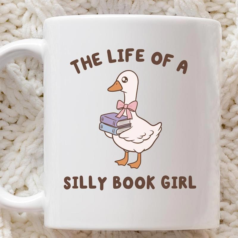 Tailorly White Ceramic 11 oz Mug - The Life Of A Silly Book Girl Whimsical White Bird Wearing Bow Carrying Stack Of Colorful Knowledge Books Goose