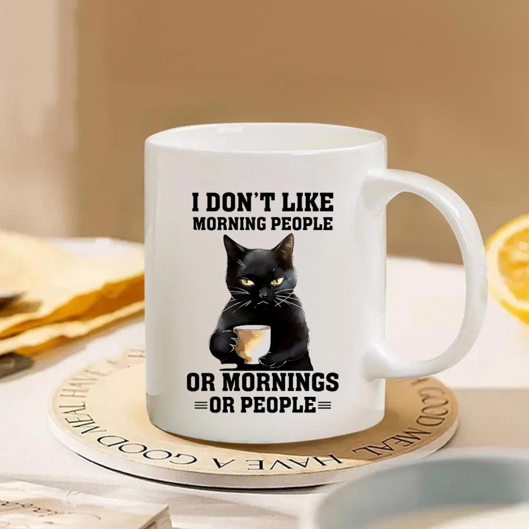 Tailorly White Ceramic 11 oz Mug - I Don't Like Morning People Or Mornings Or People Grumpy Expression Holding A Steaming Cup Of Dark Coffee Cat