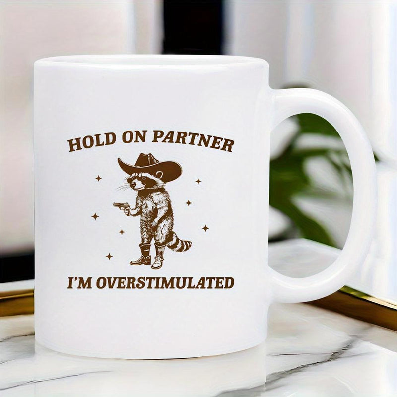 Tailorly White Ceramic 11 oz Mug - Hold On Partner Im Overstimulated Western Style Wearing Cowboy Hat And Boots Holding Small Pistol Raccoon