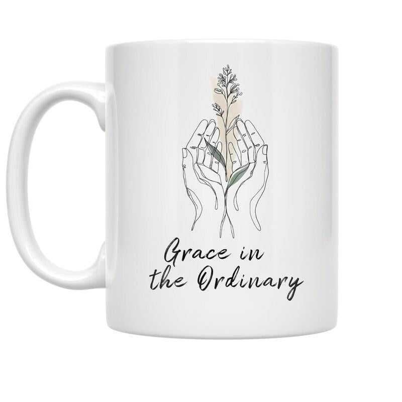 Tailorly White Ceramic 11 oz Mug - Grace In The Ordinary Minimalist Line Art Style With Delicate Botanical Stems In Cupped Palms Hands