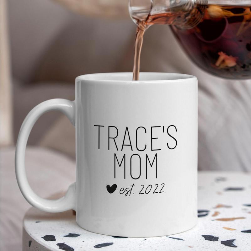 Tailorly White Ceramic 11 oz Mug - Traces Mom Est 2022 Minimalist Being Filled With Hot Pouring Liquid Mug