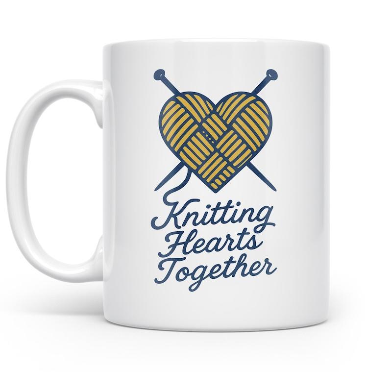 Tailorly White Ceramic 11 oz Mug - Knitting Hearts Together Classic Blue Crossed Needles Through Golden Yellow Yarn Shaped Heart