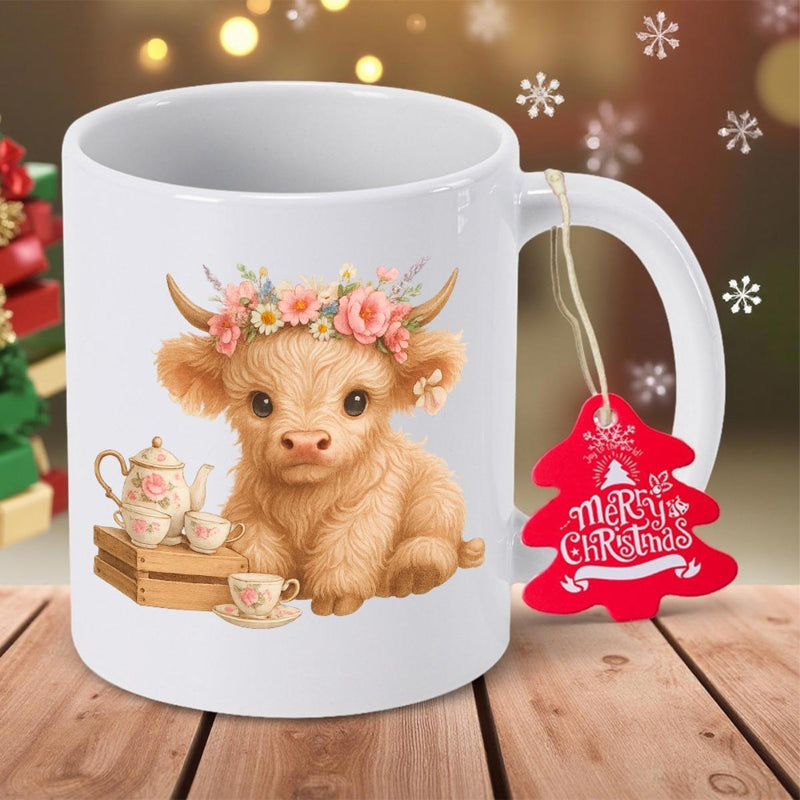 Tailorly White Ceramic 11 oz Mug - Merry Christmas Fluffy Highland Calf Wearing Delicate Pink Flower Crown Beside Teapot Cow
