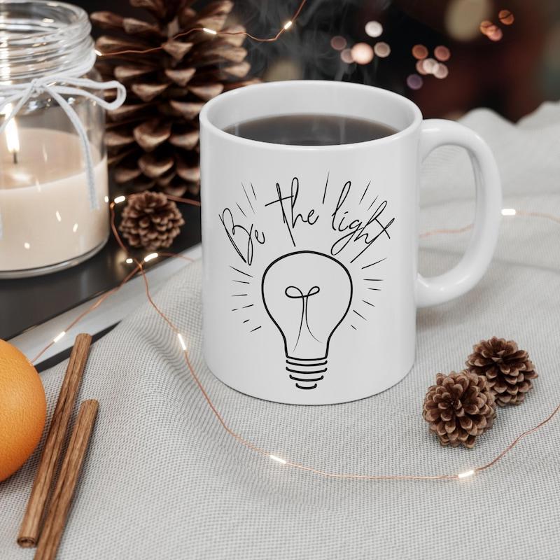 Tailorly White Ceramic 11 oz Mug - Be The Light Minimalist Glowing Hand Drawn Radiant Beaming Rays Light Bulb
