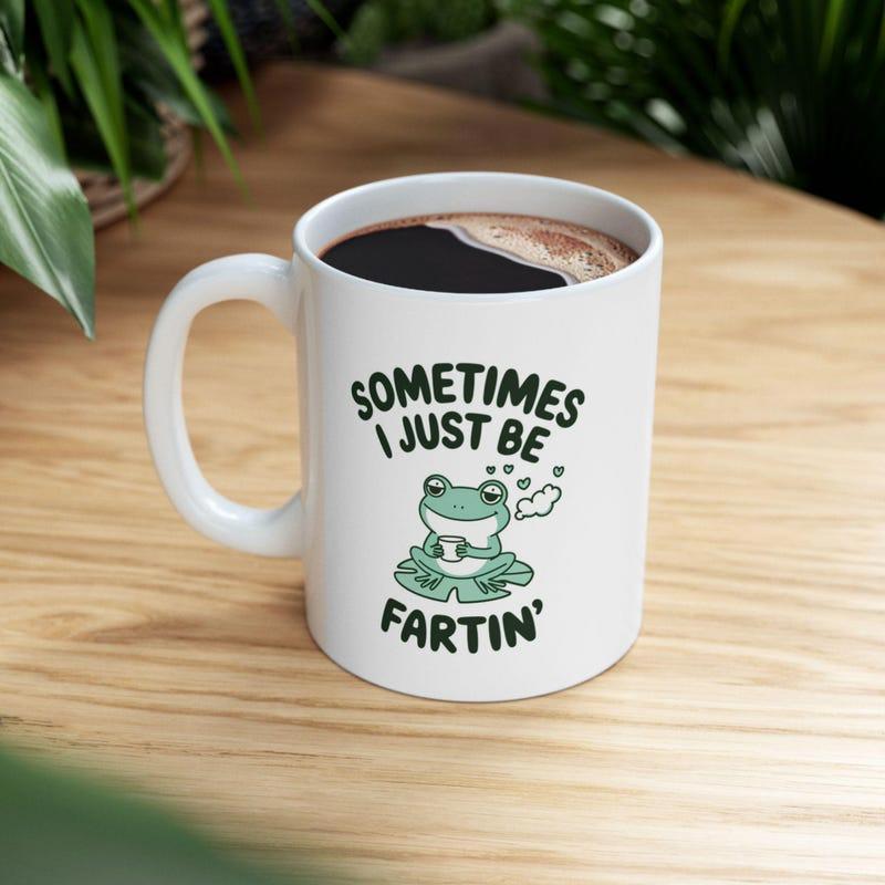 Tailorly White Ceramic 11 oz Mug - Sometimes I Just Be Fartin Cute Green Cartoon Frog Sitting On Lily Pad Holding Coffee Frog