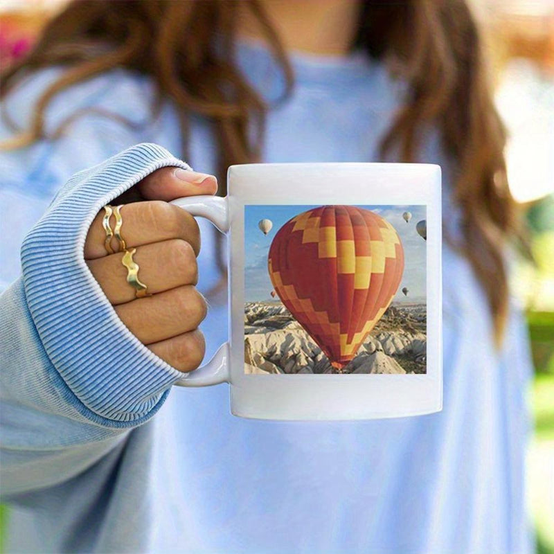 Tailorly White Ceramic 11 oz Mug - Vibrant Orange Patterned Balloon Floating Above Rugged Stone Valley Scenic Landscape Balloon