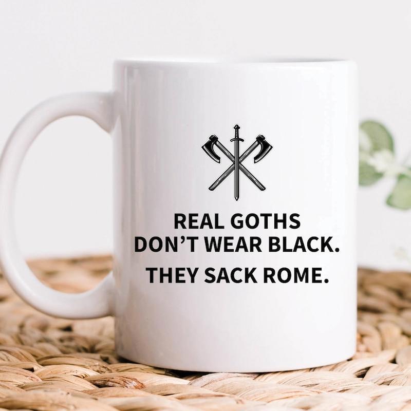 Tailorly White Ceramic 11 oz Mug - Real Goths Dont Wear Black They Sack Rome Crossed Ancient Battle Axes Behind A Vertical Sharp Warrior Steel Sword