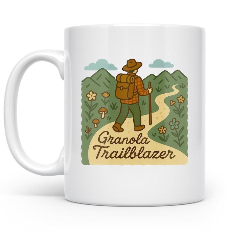 Tailorly White Ceramic 11 oz Mug - Granola Trailblazer Backpacker Walking Along Mountain Trail With Wildflowers And Clouds Hiker