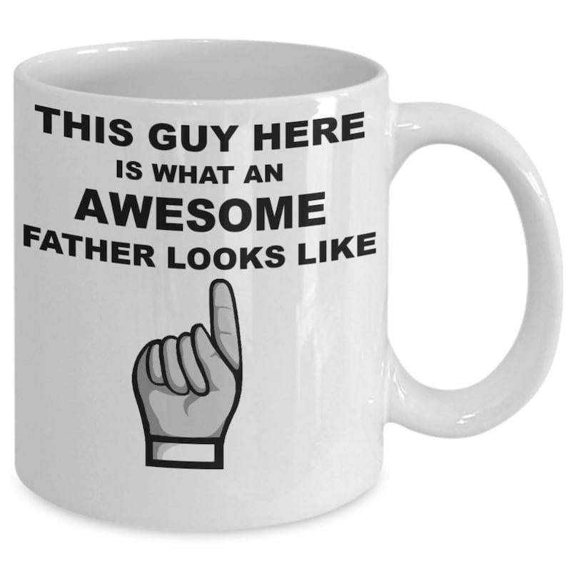 Tailorly White Ceramic 11 oz Mug - This Guy Here Is What An Awesome Father Looks Like Simple Hand With Index Finger Pointing Upwards Towards Bold Text Hand
