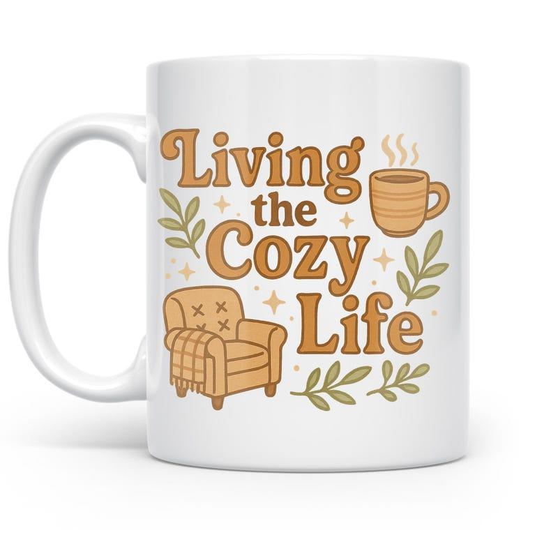 Tailorly White Ceramic 11 oz Mug - Living The Cozy Life Armchair With Throw Blanket And Steaming Coffee Among Decorative Leaves Mug