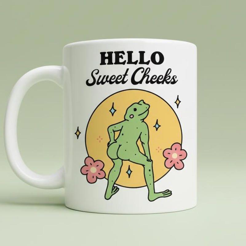 Tailorly White Ceramic 11 oz Mug - Hello Sweet Cheeks Whimsical Sassy Green Dancing Amidst Pink Flowers Under Golden Sun Frog