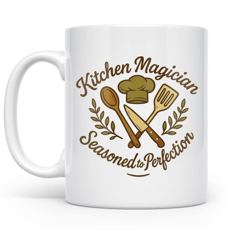 Tailorly White Ceramic 11 oz Mug - Kitchen Magician Seasoned To Perfection Crossed Culinary Utensils Between Decorative Laurel Leaves And A Chef Hat