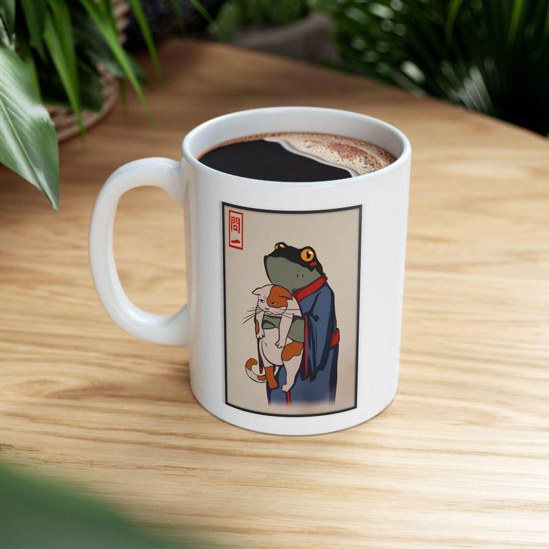 Tailorly White Ceramic 11 oz Mug - Ancient Japanese Style Illustration With Kimono Wearing Creature Cradling A Calico Frog