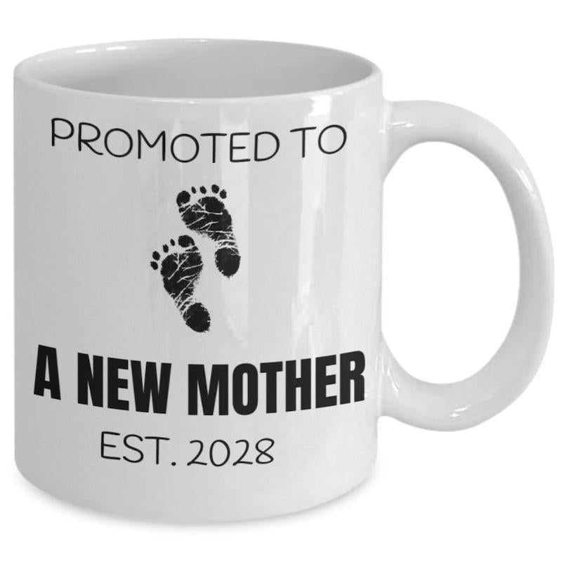 Tailorly White Ceramic 11 oz Mug - Promoted To A New Mother Est 2028 Tiny Baby Feet Graphics Printed In Black Ink Footprints