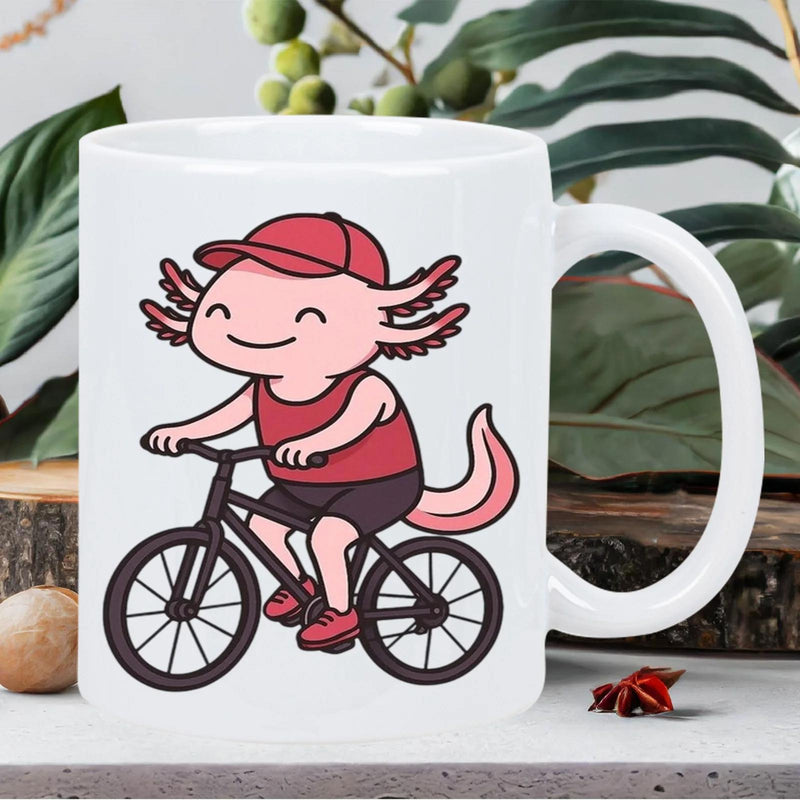 Tailorly White Ceramic 11 oz Mug - Cute Pink Cartoon Character Wearing A Red Cap Riding A Bicycle Axolotl