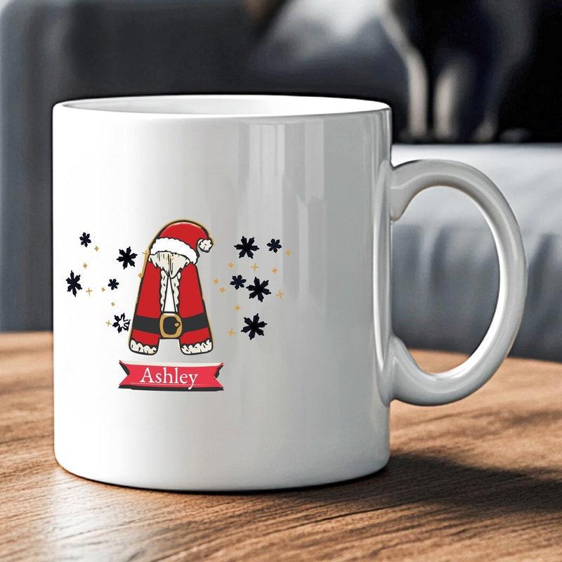 Tailorly White Ceramic 11 oz Mug - Ashley Festive Christmas Initial Wearing Santa Outfit With Delicate Black Stars Letter