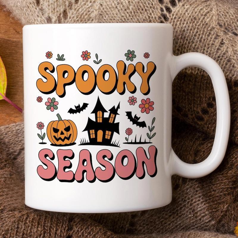 Tailorly White Ceramic 11 oz Mug - Spooky Season Retro Halloween Scene With Carved Pumpkin And Flying Bats Among Flowers Haunted House