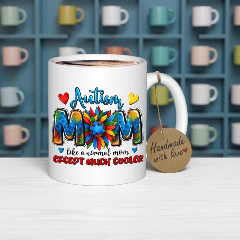 Tailorly White Ceramic 11 oz Mug - Autism Mom Like A Normal Mom Except Much Cooler Vibrant Colorful Puzzle Patterns Inside Text With A Central Petaled Sunflower