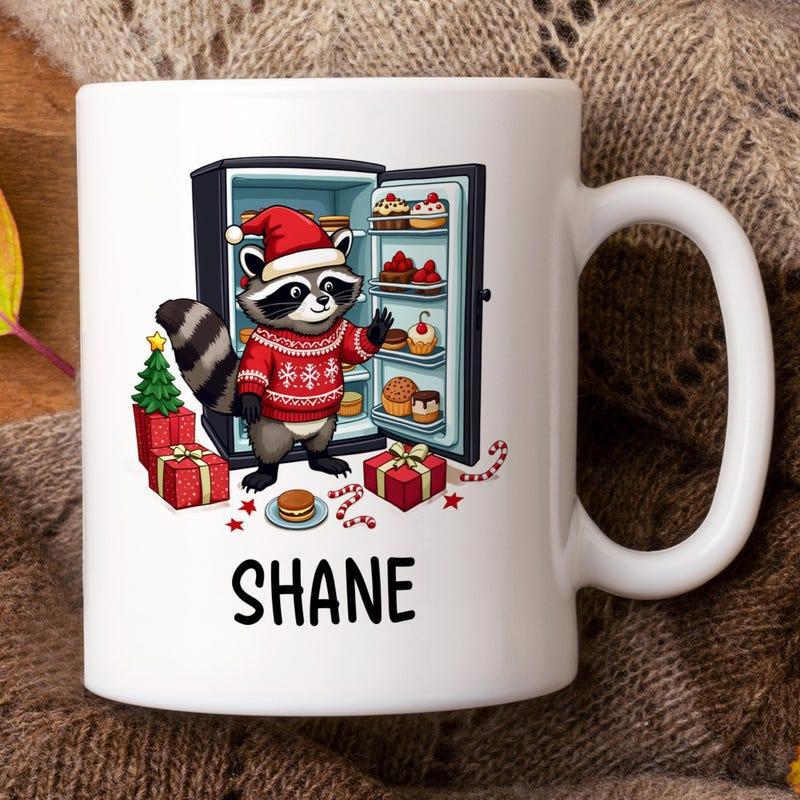 Tailorly White Ceramic 11 oz Mug - Shane Festive Raccoon Wearing Red Sweater Near A Holiday Themed Refrigerator Raccoon