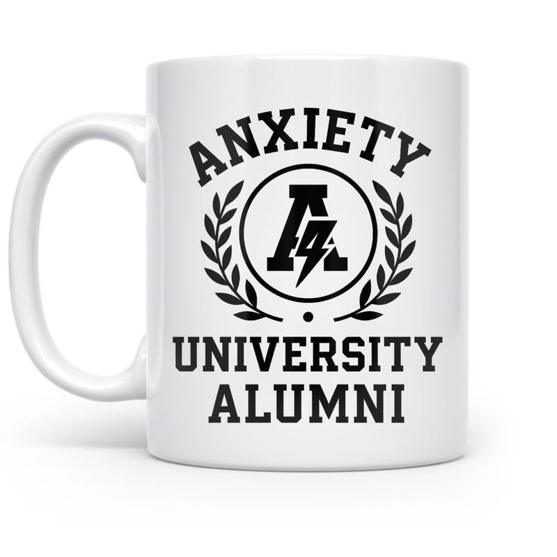 Tailorly White Ceramic 11 oz Mug - Anxiety University Alumni Classic Collegiate Laurel Wreath Surrounding A Central Letter A With Lightning Bolt Mug