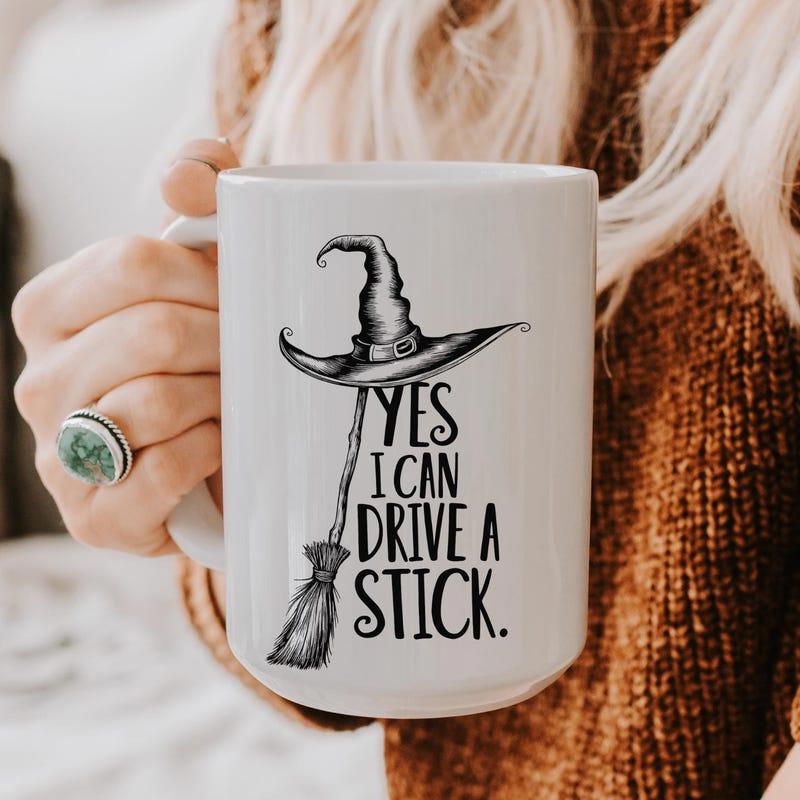 Tailorly White Ceramic 11 oz Mug - Yes I Can Drive A Stick Pointy Witch Hat Floating Above A Classic Hand Drawn Magic Broomstick