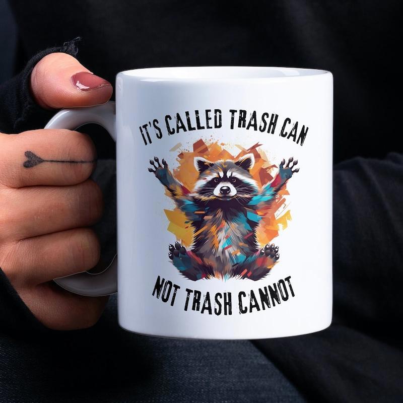 Tailorly White Ceramic 11 oz Mug - Its Called Trash Can Not Trash Cannot Colorful Artistic Paint Splatters Around A Sitting Happy Wildlife Raccoon