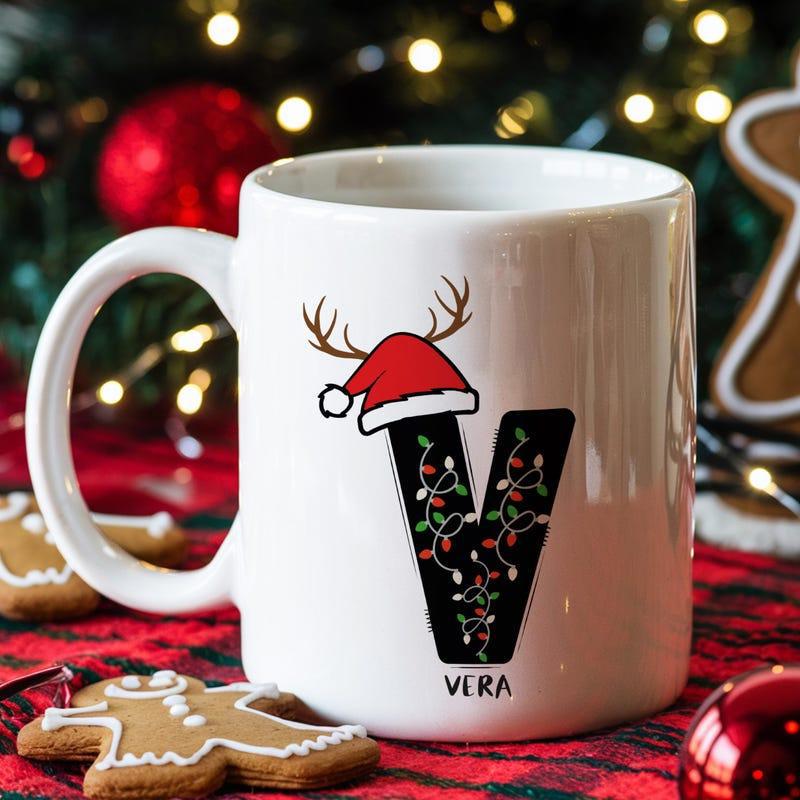 Tailorly White Ceramic 11 oz Mug - Vera Large Letter With Santa Hat And Reindeer Antlers Wrapped In String Lights Mug