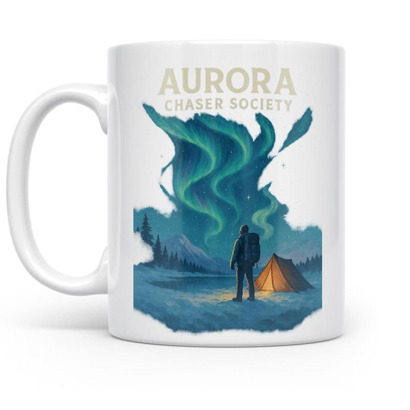 Tailorly White Ceramic 11 oz Mug - Aurora Chaser Society Glistening Green Lights Dancing Above A Lone Hiker And Camping Landscape