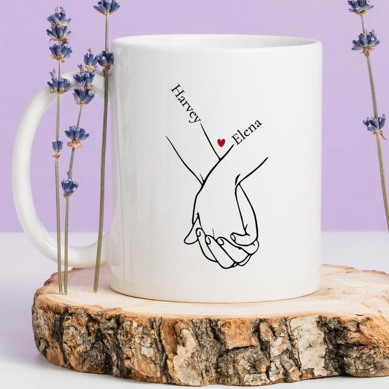 Tailorly White Ceramic 11 oz Mug - Harvey Elena Minimalist Black Line Drawing Depicting Two Intertwined Fingers And Sweet Heart Hands