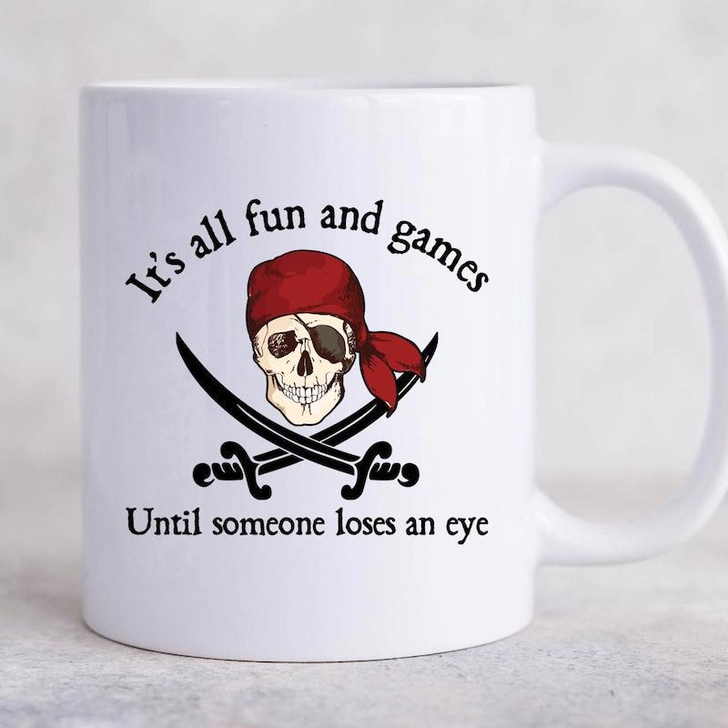 Tailorly White Ceramic 11 oz Mug - Its All Fun And Games Until Someone Loses An Eye Classic Pirate Jolly Roger With Red Bandana And Crossed Sharp Cutlasses Skull