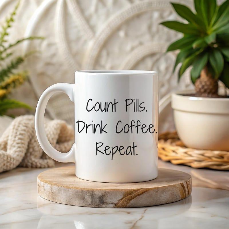 Tailorly White Ceramic 11 oz Mug - Count Pills Drink Coffee Repeat Minimalist Ceramic Vessel Featuring Simple Handwritten Text Resting On Wood Mug