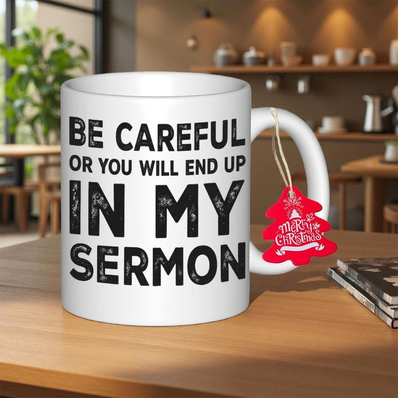 Tailorly White Ceramic 11 oz Mug - Be Careful Or You Will End Up In My Sermon Featuring Bold Textured Black Lettering On Wooden Table Mug